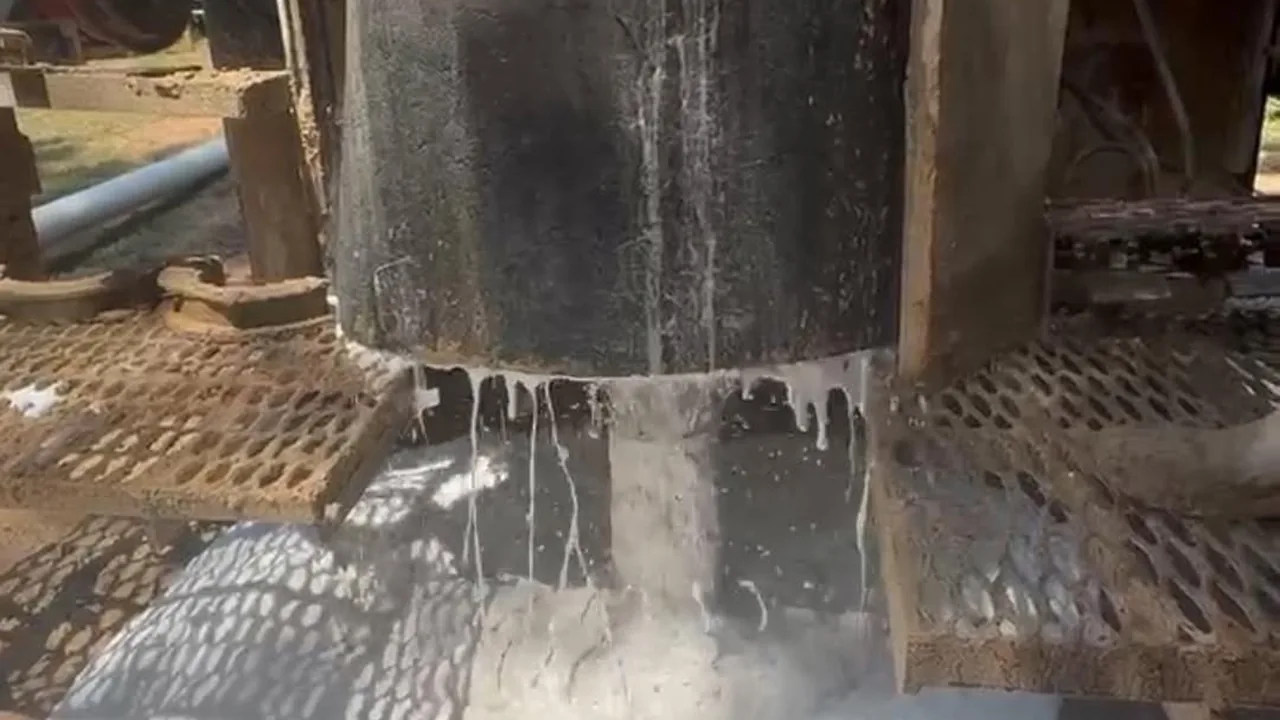 Water surging up around the drill stem and washing across the rig deck as the well comes in